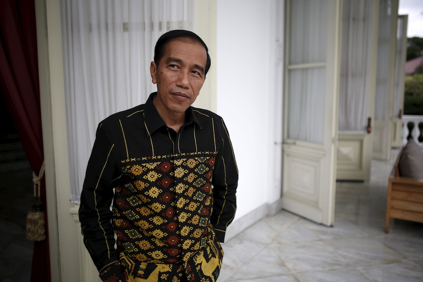 A middle-aged Indonesian man with a batik shirt