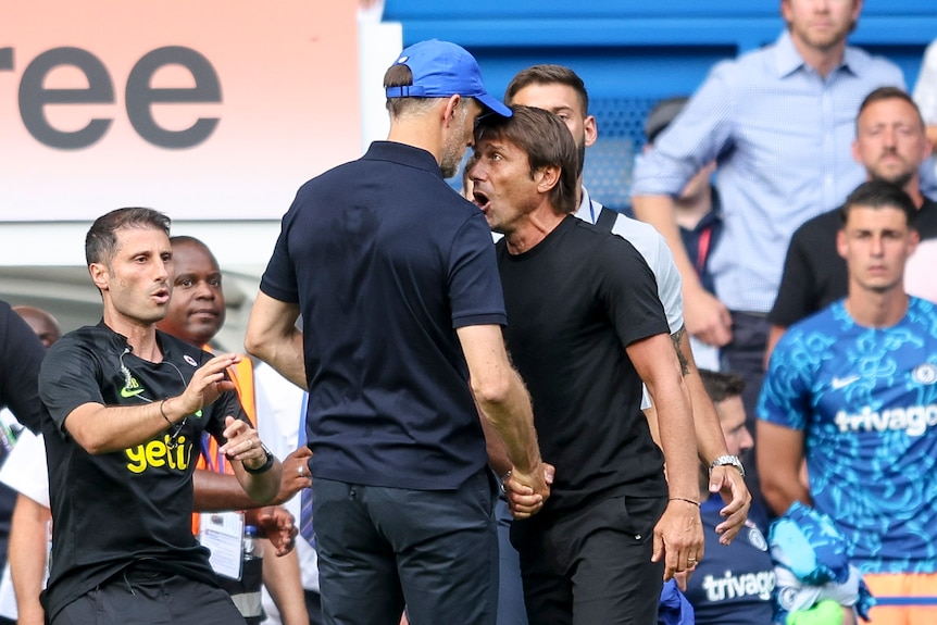 Tottenham and Chelsea managers Thomas Tuchel and Antonio Conte have their faces very close together as they clash at a game.