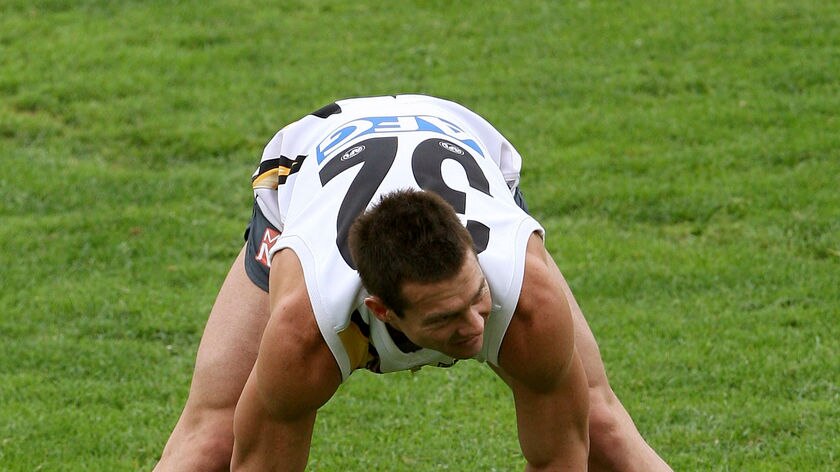 Ben Cousins stretches during a training session