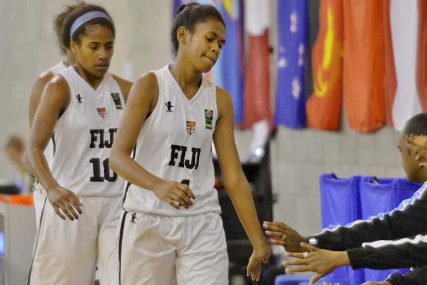 Tiyana give a 'low five' to the bench while wearing her national uniform.