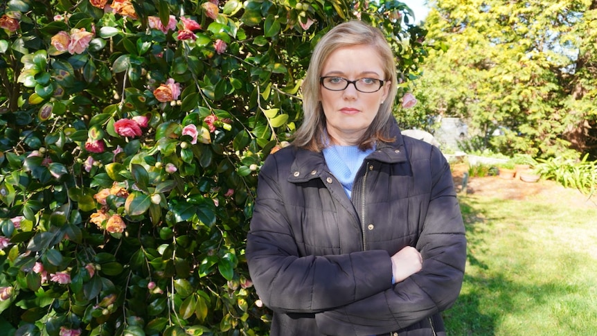 A woman frowns at the camera.