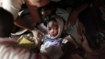 An injured child receives medical treatment in Haiti (Reuters: Eduardo Munoz)