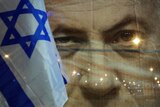 A banner depicts Israeli Prime Minister Benjamin Netanyahu next to an Israeli flag during a protest.