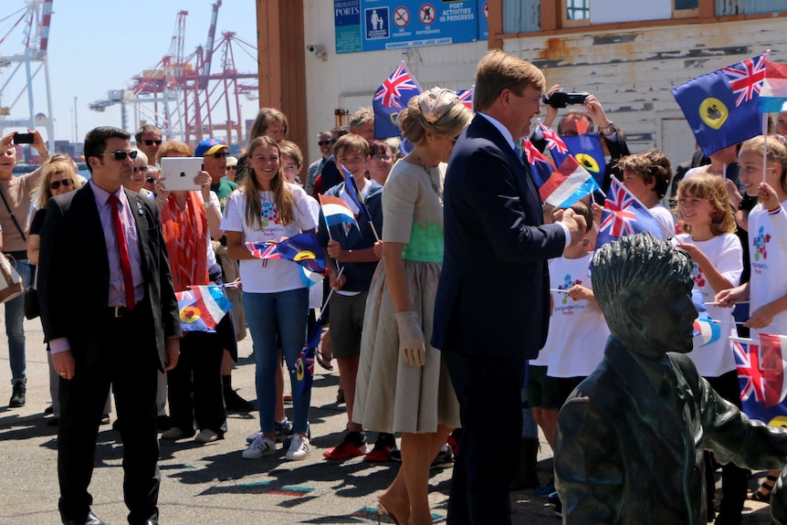 Students wave WA and Dutch flags as they greet Dutch Royals in Fremantle.