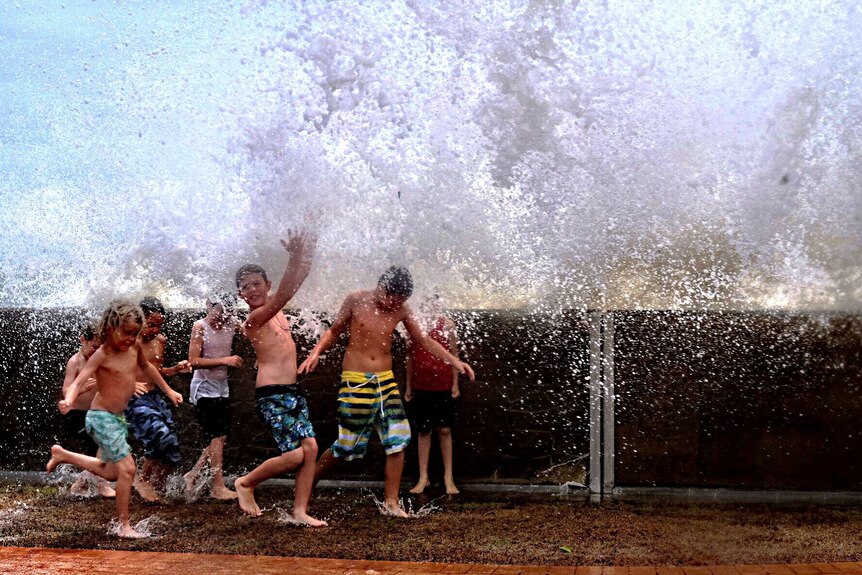 Children play in the waves at Hervey Bay following Cyclone Marcia
