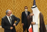 An Israeli official and his Bahraini counterpart bump elbows.