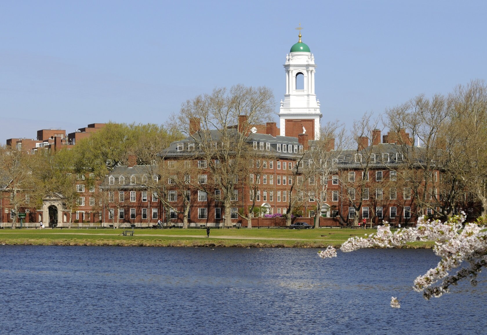 brown brick building on a river's edge