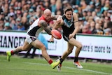 Melbourne's Nathan Jones competes with Port Adelaide's Jared Polec at Adelaide Oval.