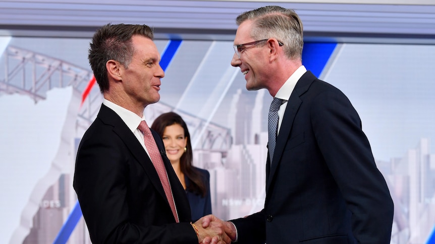 NSW Labor leader Chris Minns (left), and NSW Premier Dominic Perrottet shake hands following a NSW Leaders Debate in Sydney, Wednesday, March 8, 2023. AAP: Bianca De Marchi