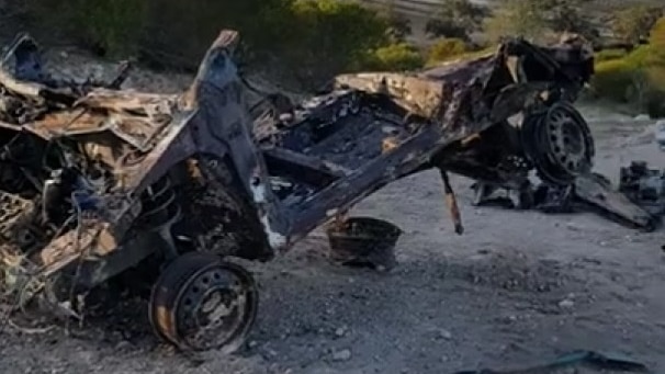 The wrecked remains of a car after being dug up by police.