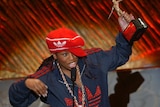 Missy Elliott holds up the Michael Jackson Award for best R&B/Soul or Rap Music Video in celebration.