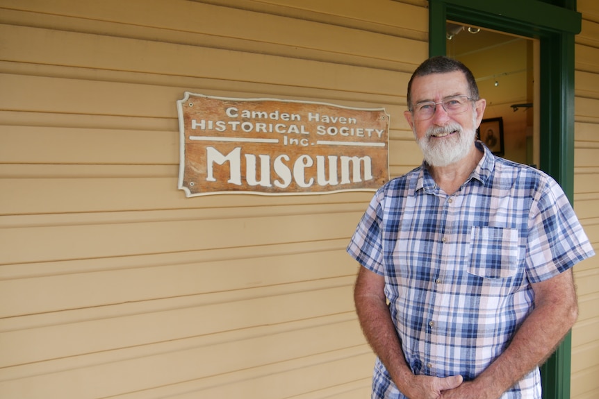 A man stands outside a small wooden historical museum on the New South Wales Mid North Coast