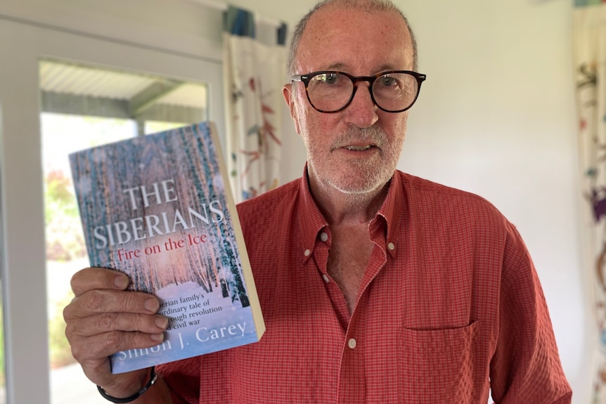Simon Carey poses with his book The Siberians