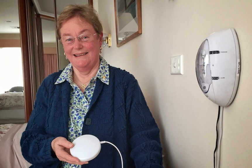 Sue Daw, from Better Hearing Australia, with her fire alarm and shaker pad.