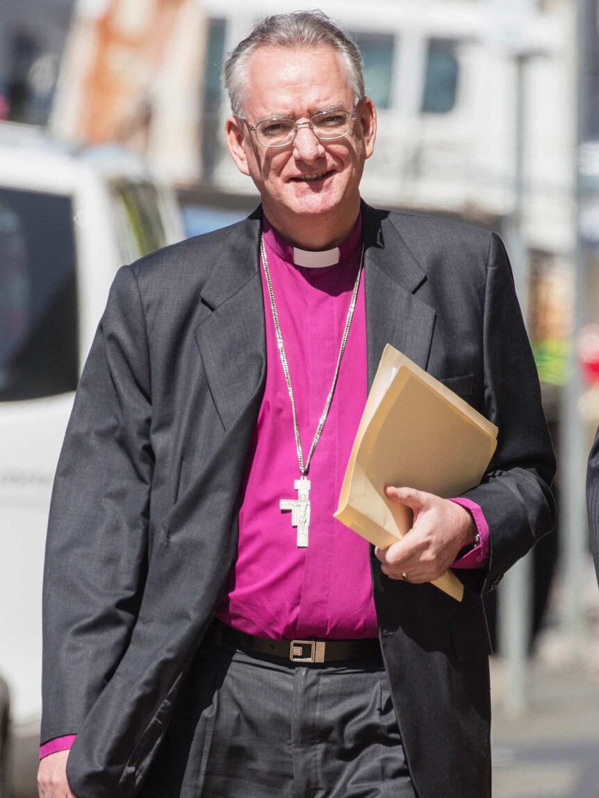 Front on photo of Archbishop of Brisbane Phillip Aspinall walking down a street on his way to the Royal Commission.
