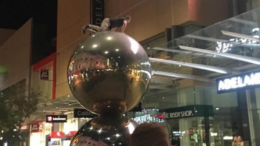A daredevil on top of the Malls Balls in Rundle Mall.