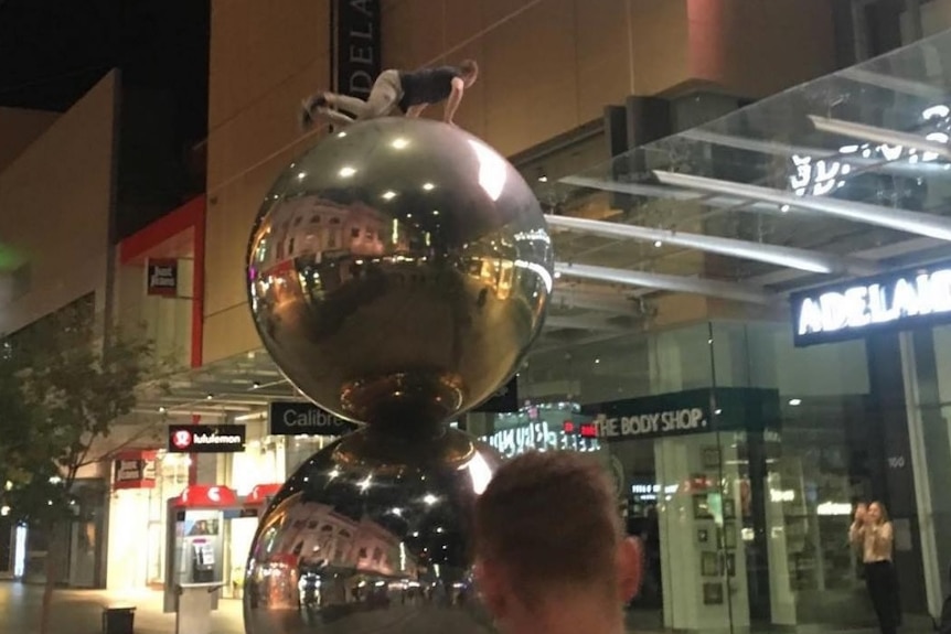 A daredevil on top of the Malls Balls in Rundle Mall.