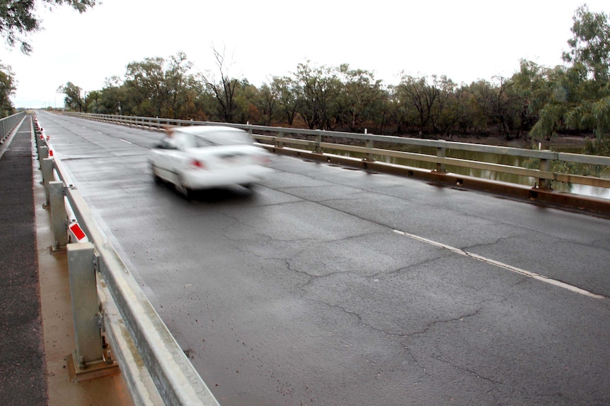 A car drives across the Darby Land Bridge.