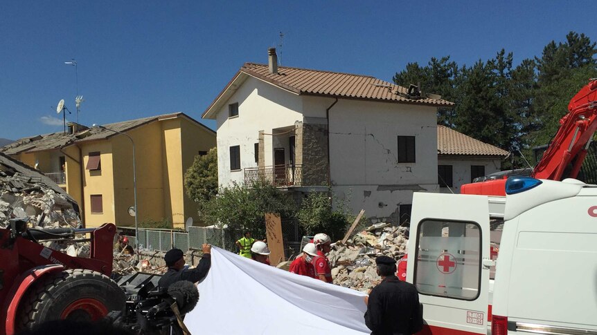 The sheet goes up and another body is removed in retrieval efforts in Amatrice