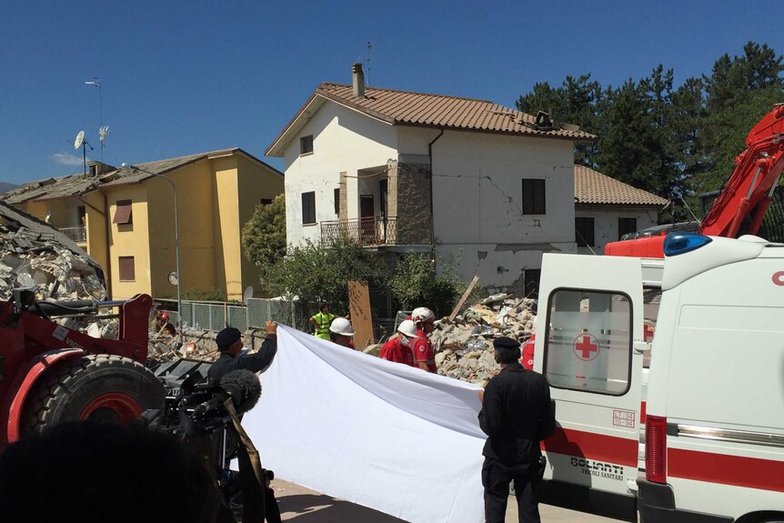 The sheet goes up and another body is removed in retrieval efforts in Amatrice