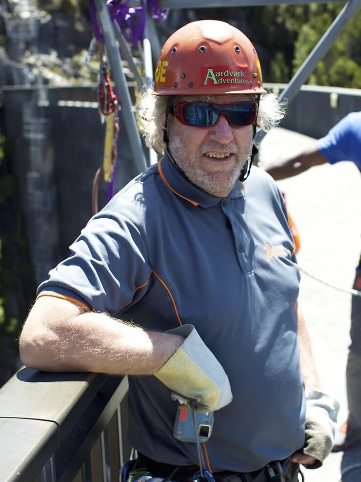 Phil Harris, operator of abseiling tour company, pictured in abseiling gear on a dam wall.