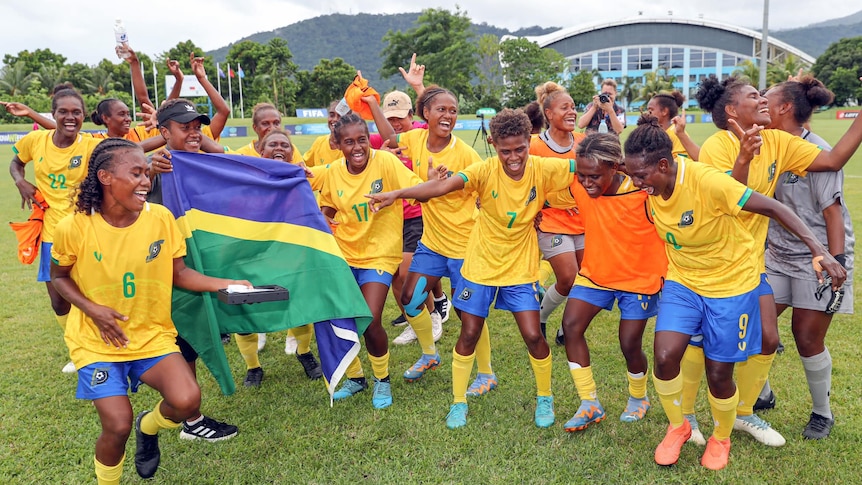 Solomon Islands Women's Football team celebrate smiling, laughing and dancing after their win against Samoa in their semi-final 