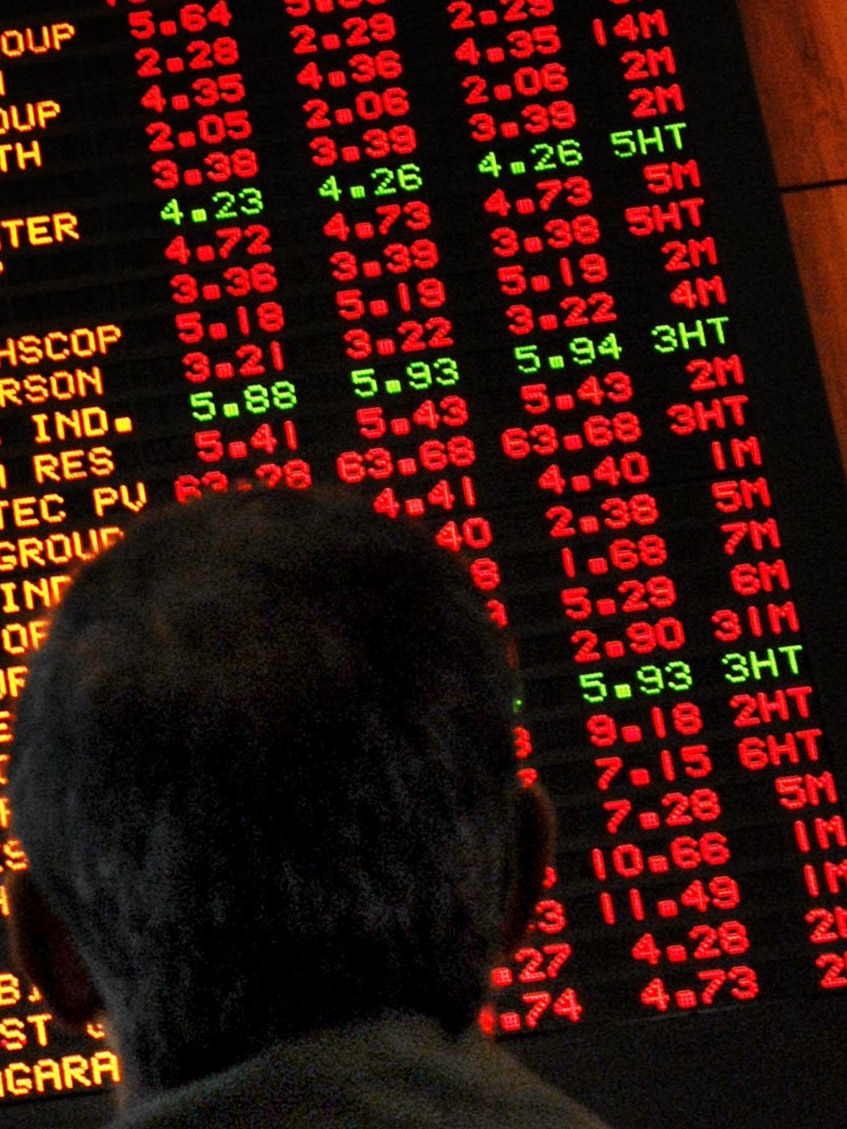 An investor watches the boards at the Australian Stock Exchange in August 2007. (AAP: Dean Lewins, file photo)