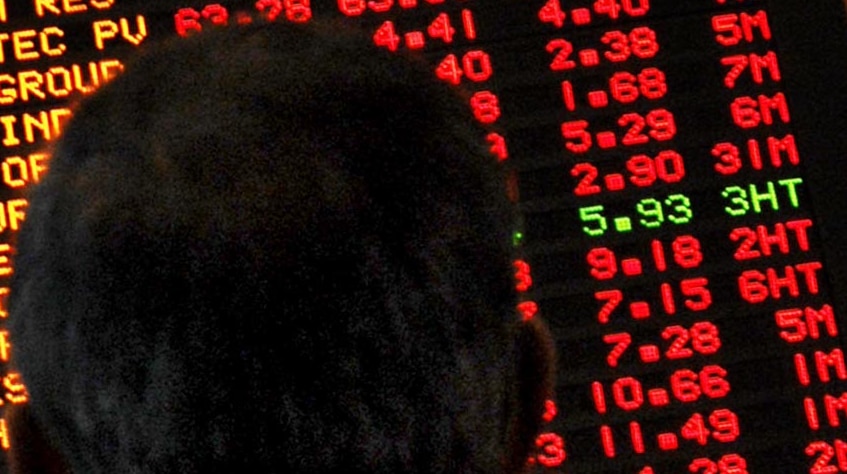 An investor watches as stocks on ASX dive