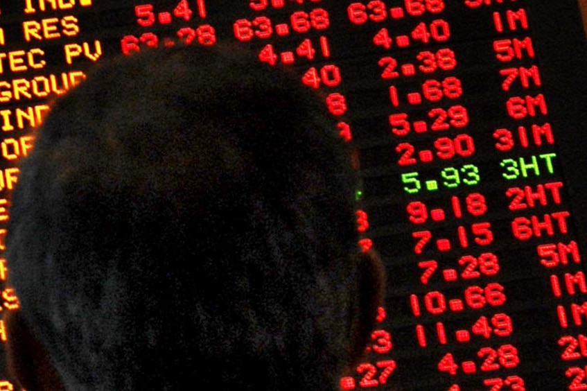 An investor watches as stocks on ASX dive