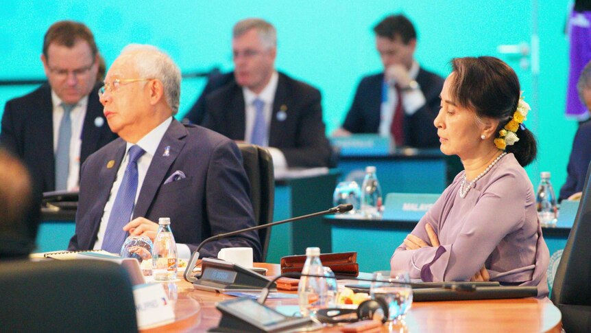 Aung San Suu Kyi sits at a table at the ASEAN delegation