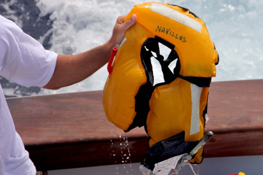 Search crew recover a lifejacket from the wrecked yacht Navillus off Late Island