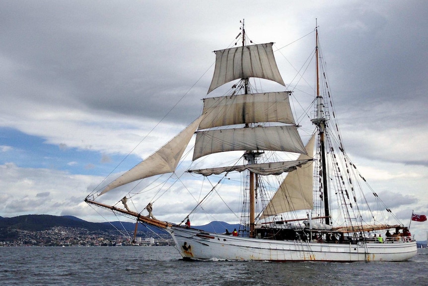 A tall ship makes its way up the River Derwent.