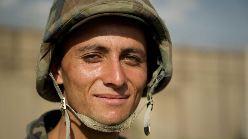 A close-up of a young Afghan soldier.