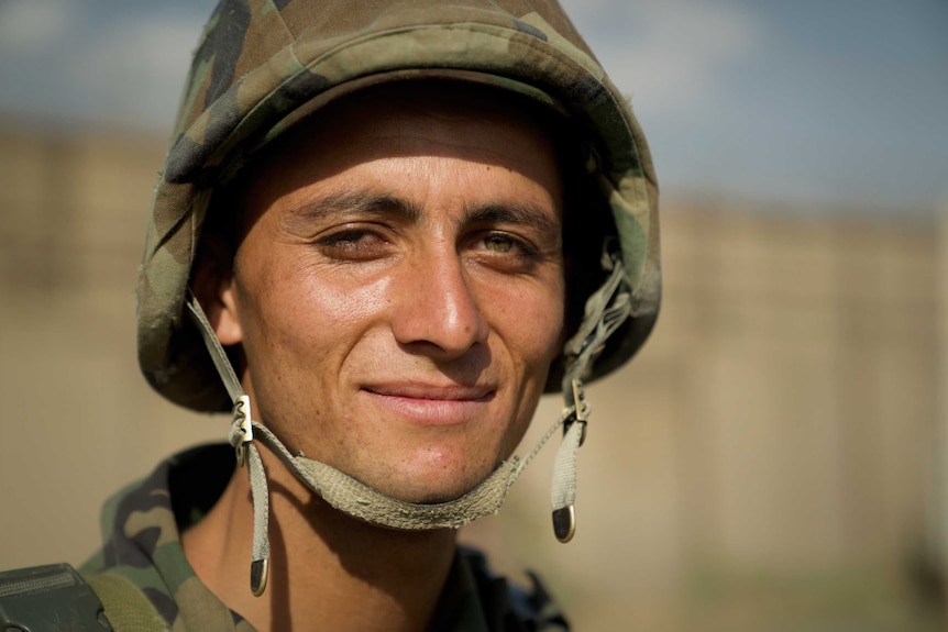 A close-up of a young Afghan soldier.