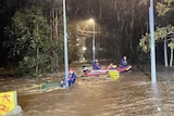 People pictured on boats during a flood rescue in Holsworthy