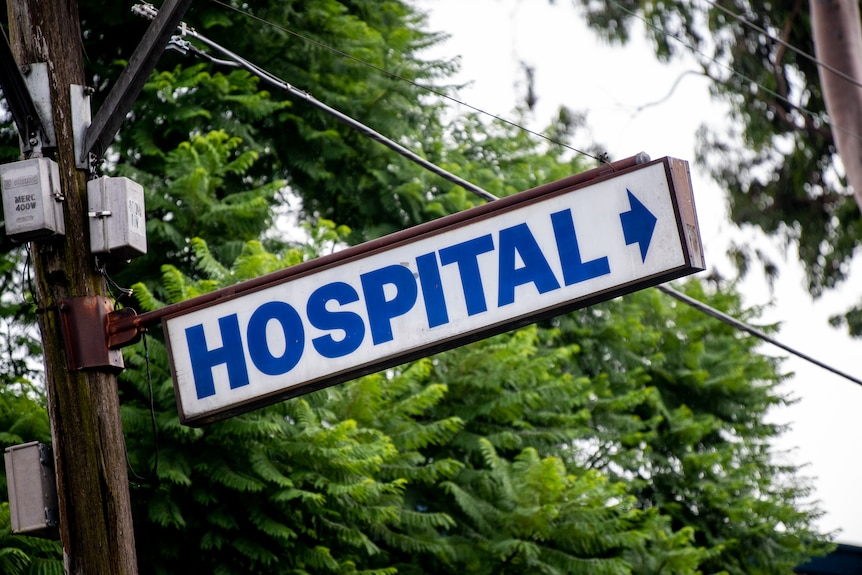 A sign with an arrow reading 'hospital'