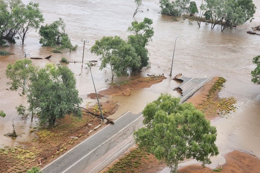 A bridge and parts of highway submerged in floodwater.