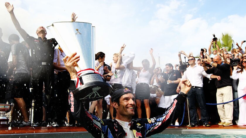 Mark Webber wades in Red Bull's swimming pool, showing off the Monaco title that took him to the top of the F1 standings.