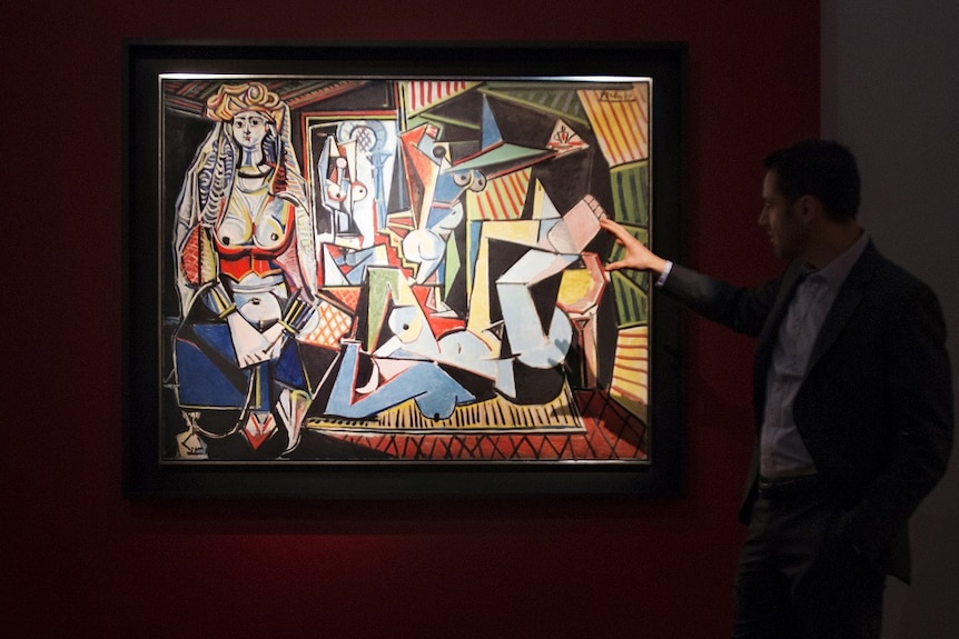 A man views Picasso's painting Les femmes d'Alger (Version 'O')
