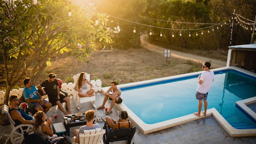 Young people drinking by pool