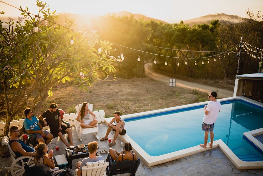 Young people drinking by pool