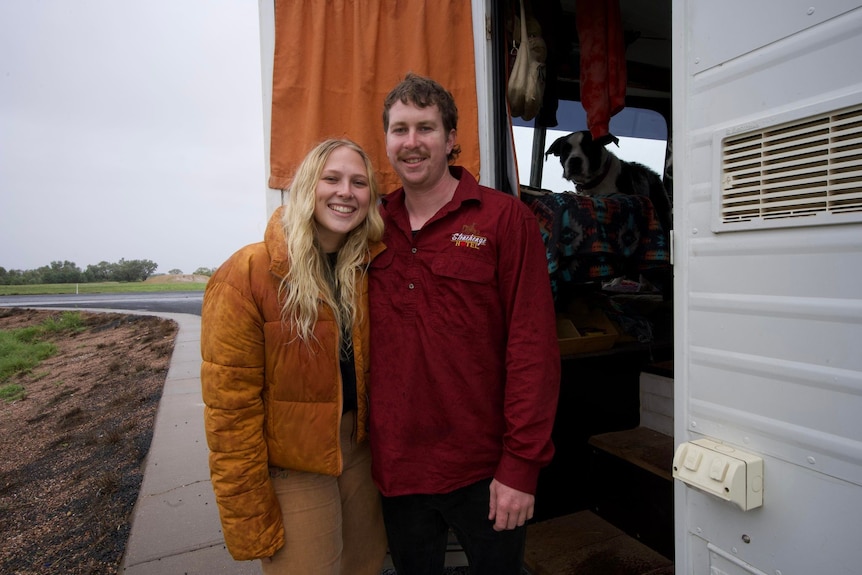 Woman in orange jacket and man in red shirt 