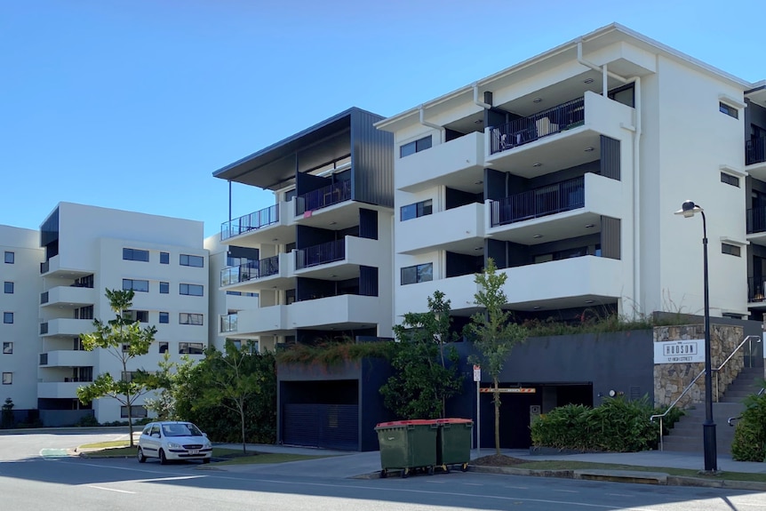 A multi-storey apartment complex on a sunny day.