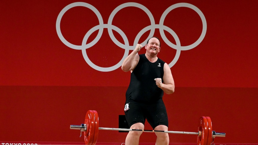 Lauren Hubbard smiles and punches the air after a successful lift in the women's 87kg weightlifting at the Tokyo Olympics. 