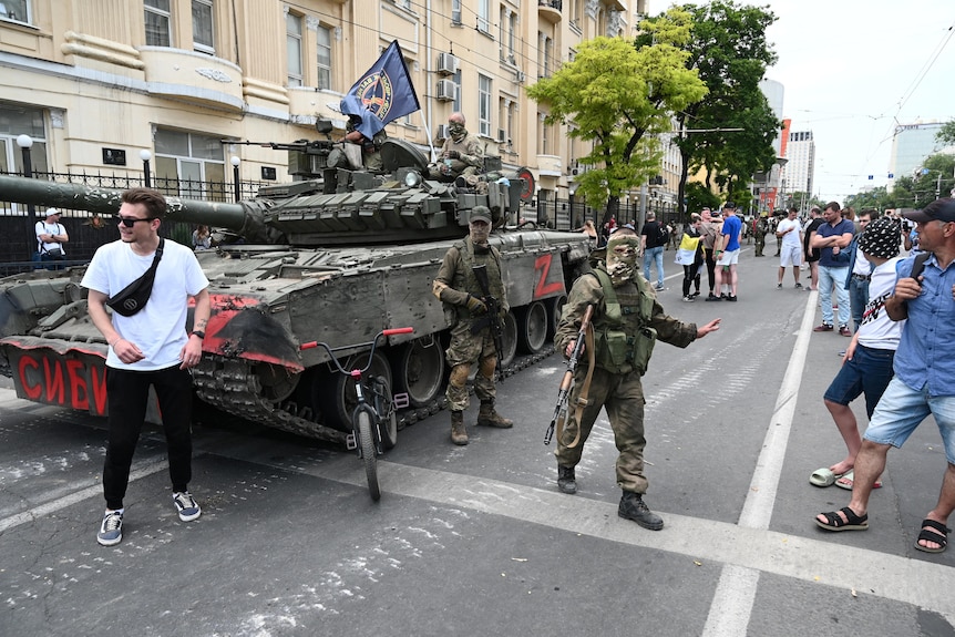 People gather in a street as fighters of Wagner private mercenary group are deployed in a southern Russia city. 