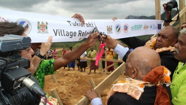 The ribbon is cut to officially mark the beginning of the rebuilding of Tukuraki Village