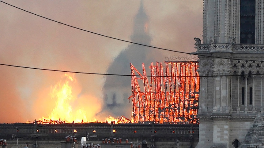 Triangular roof support struts glow orange as they burn and collapse.