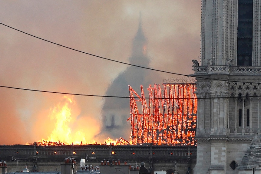 Triangular roof support struts glow orange as they burn and collapse.