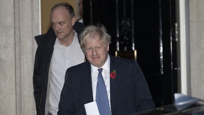 two men walk out of a doorway