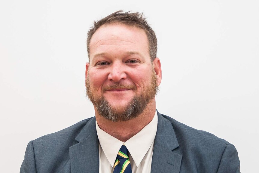Smiling headshot of Cloncurry Councillor Damien McGee in north-west Queensland.